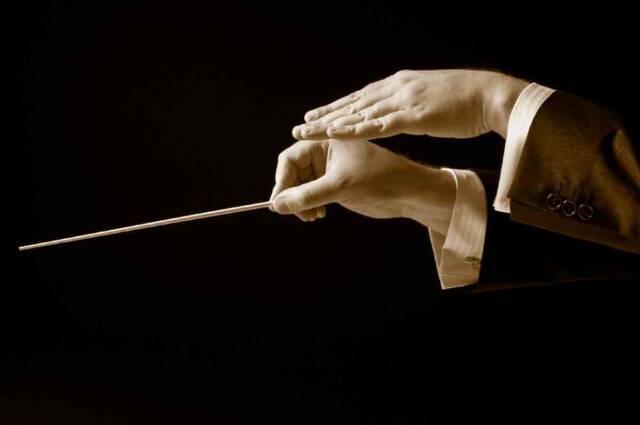 Italian conductor hands with baton- Tuscan Weddings and Events
